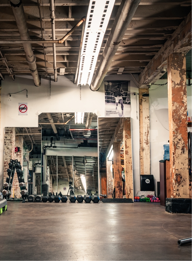 Private studio training wall with mats and equipment.