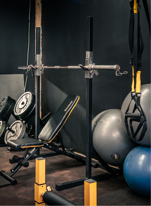 Private studio training wall with mats and equipment.