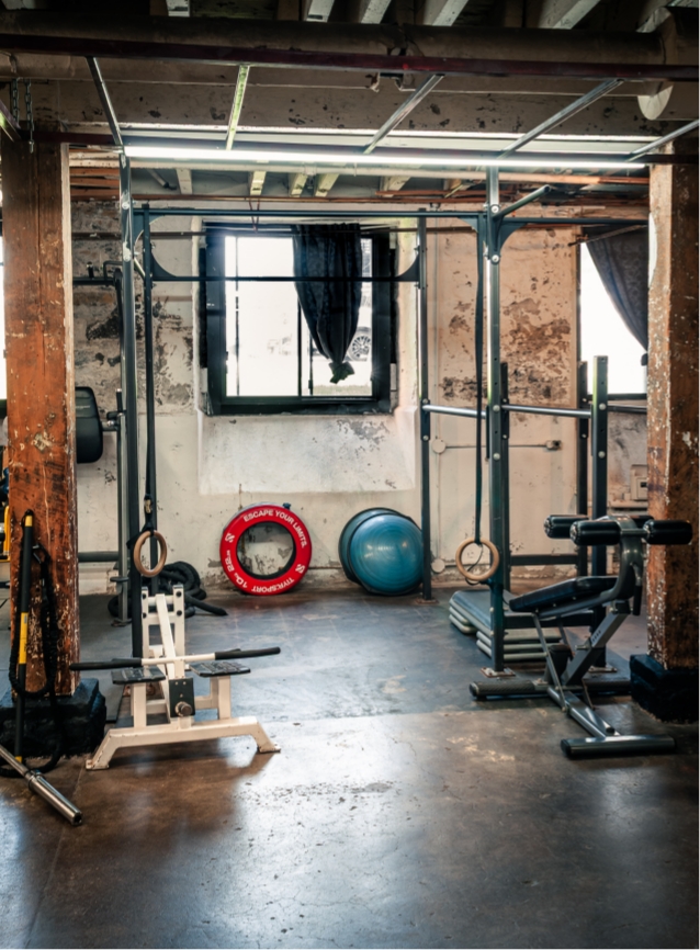 Private studio training wall with mats and equipment.